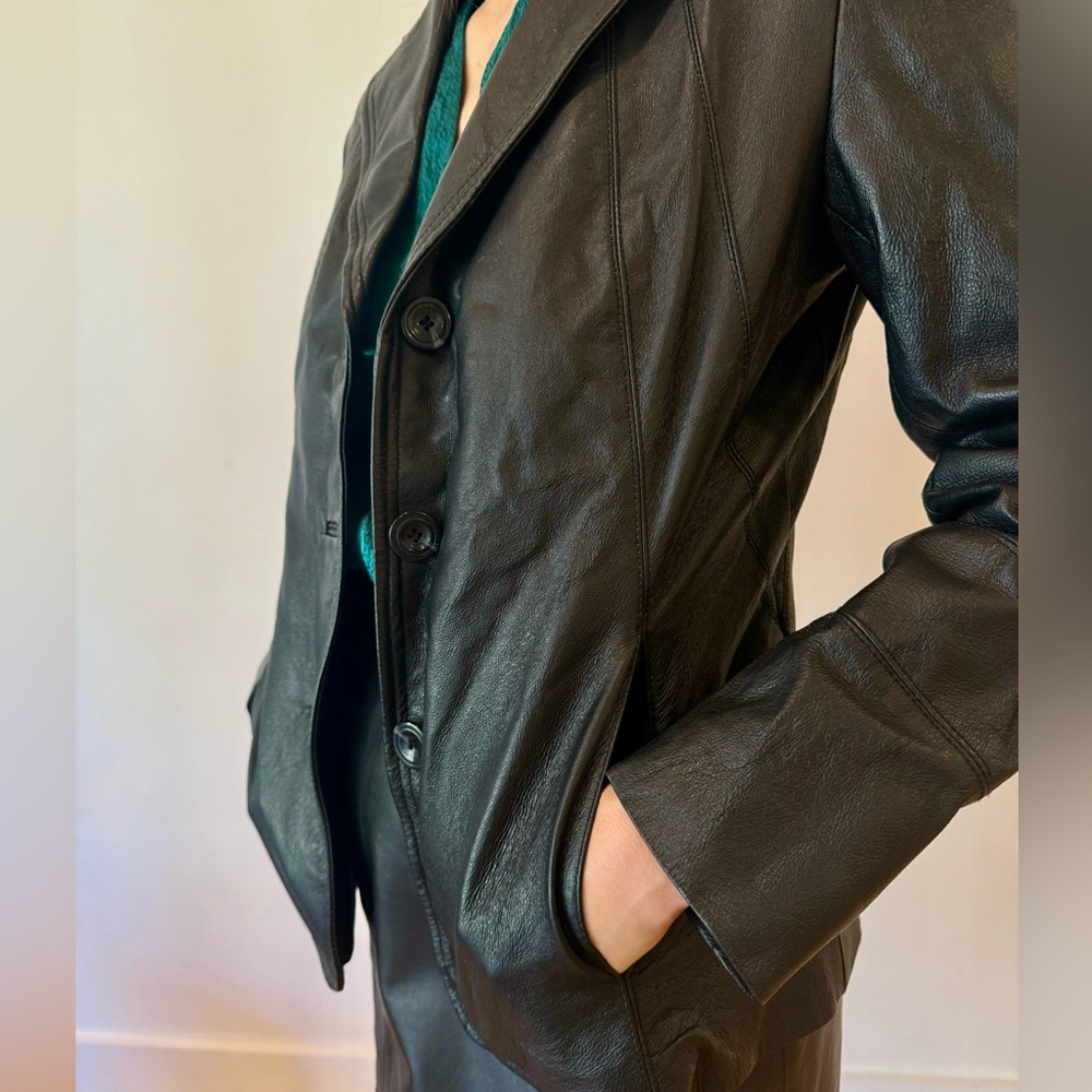 100% leather blazer. Excellent condition, structured fit.
